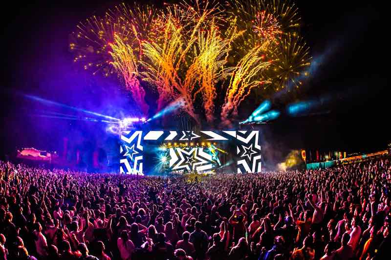 Fans dancing with fireworks at Creamfields South